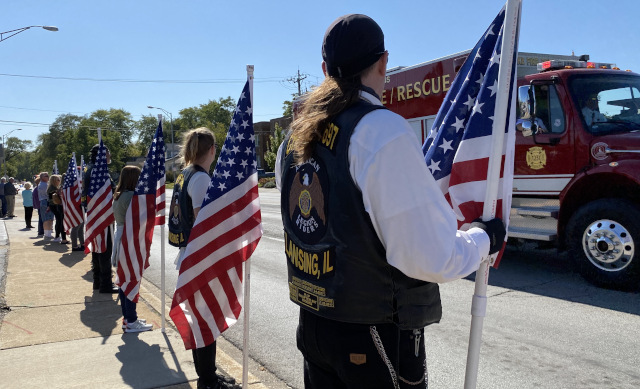 Members of Lansing's Legion Riders lined up along Burnham Ave. and held flags in support. (Photo: Melanie Jongsma)