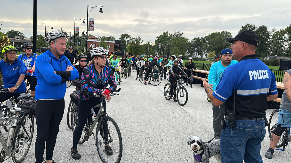 Lansing Police Chief Al Phillips and his dog Bailey greeted bikers and gave instructions before the start of the ride. (Photo: Melanie Jongsma)