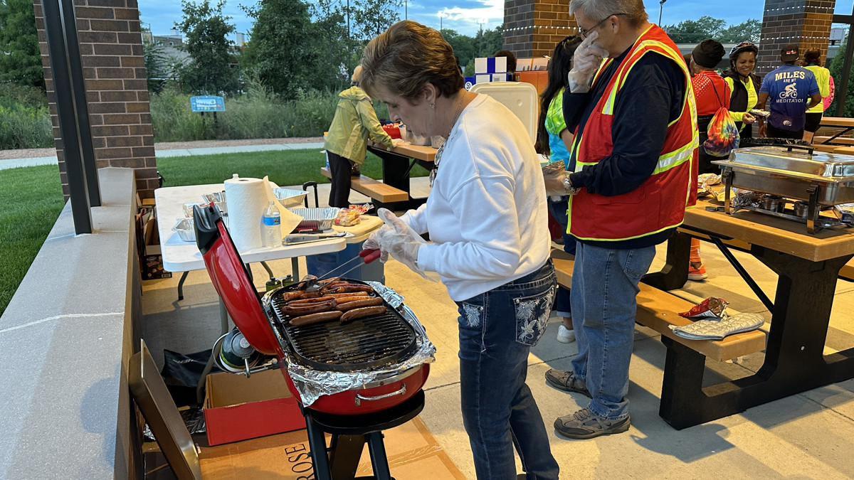 Back at the Fox Pointe pavilion, Chamber Board members grilled hot dogs for hungry bikers. (Photo: Melanie Jongsma)