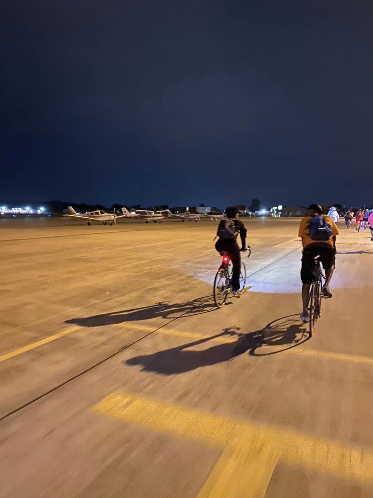 The second leg of the trip took bikers to the Lansing Municipal Airport, where they biked along the taxiway. (Photo: Sally Blom)